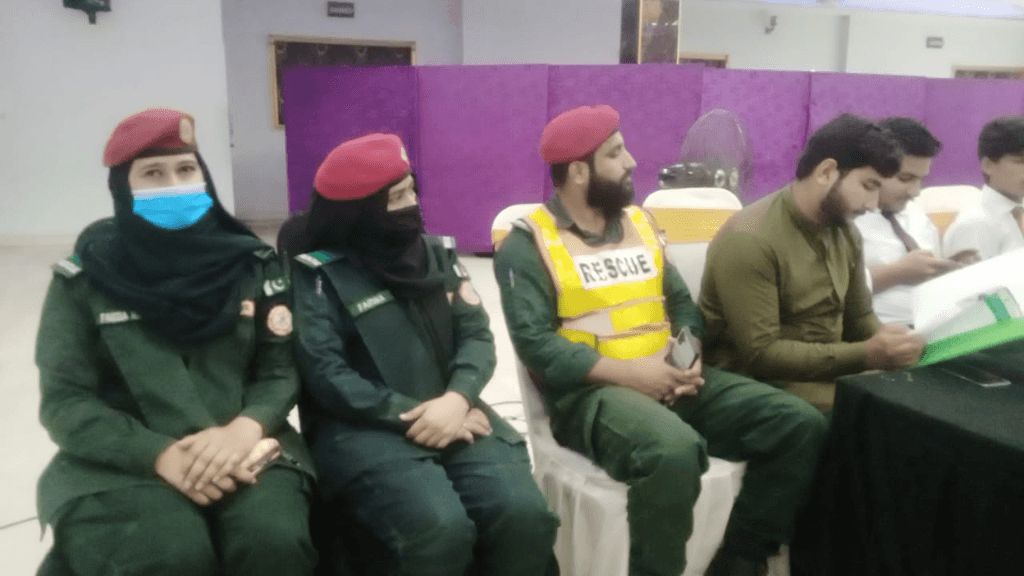 Rescue 1122 officers seated during consultation